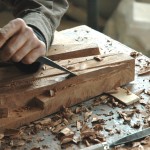 Richard Knox carving a wood sculpture.